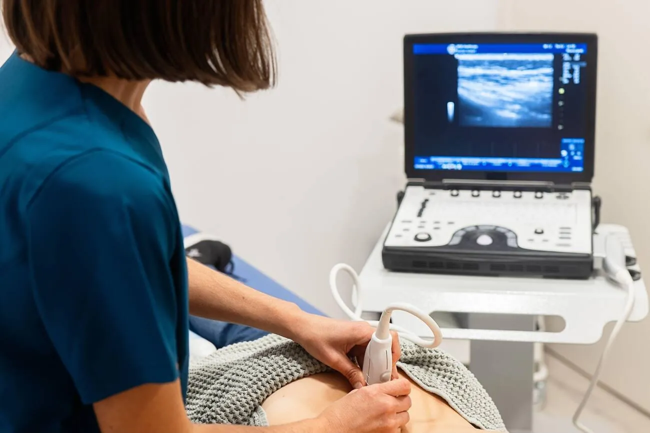 Sonographer performing an abdominal ultrasound scan
